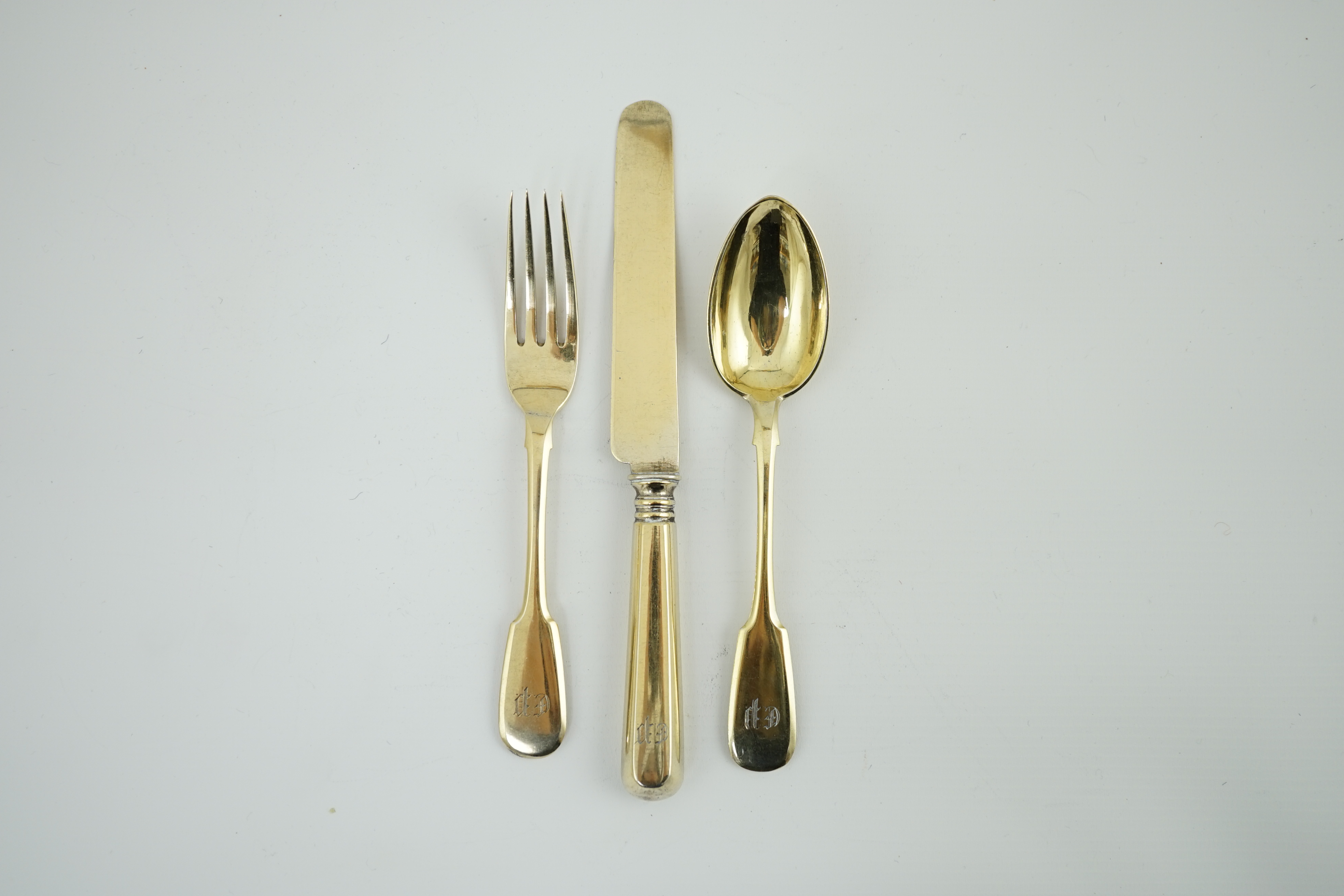 A set of six late 19th century Russian 84 zolotnik silver gilt fiddle pattern dessert spoons, a set of six matching dessert knives and dessert forks, master Alexander Matisyev and A. Krilov, unknown assay master, Moscow,